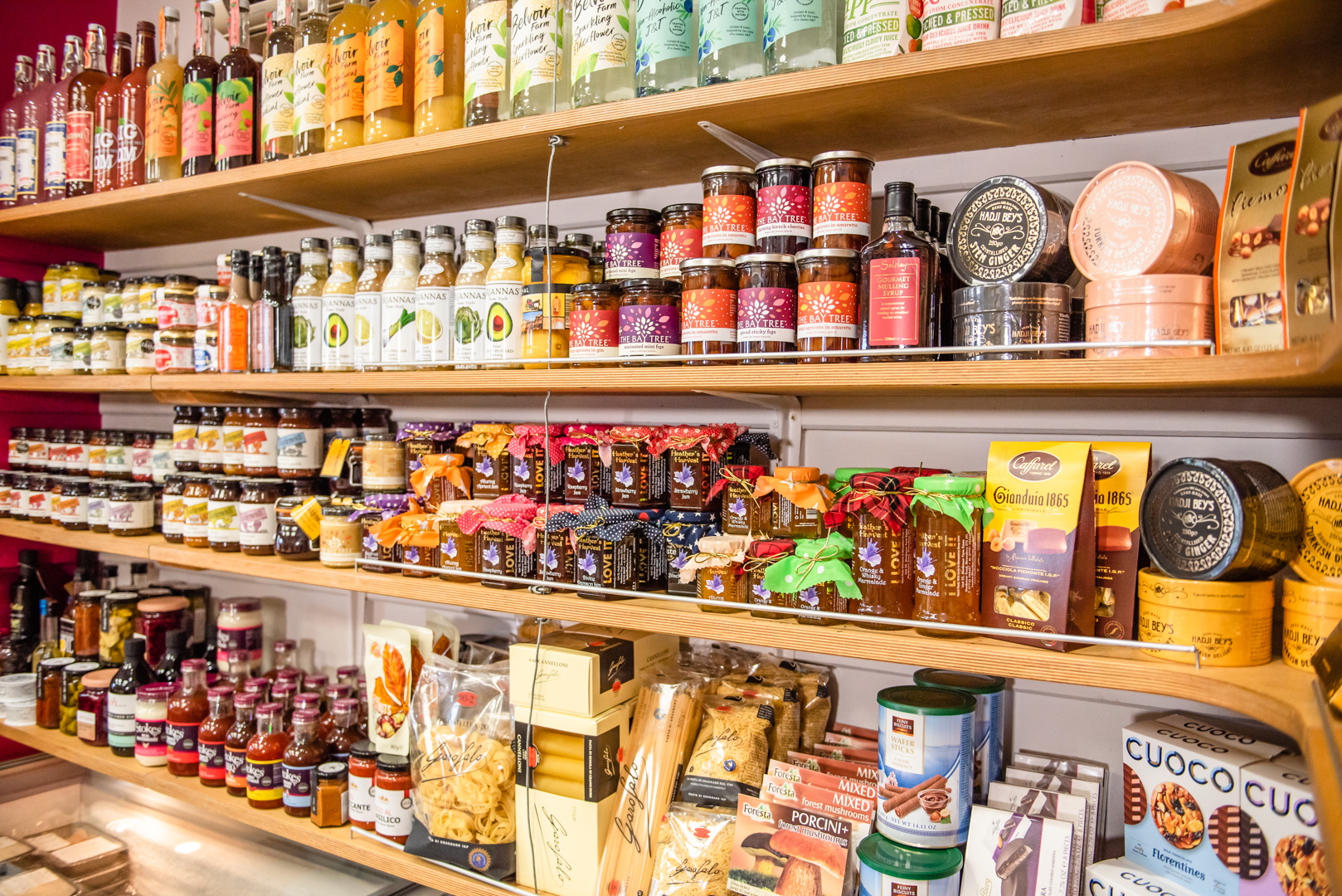 Deli shop shelves with jars of pickles, jams and speciality foods